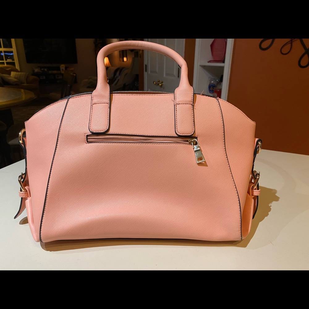 Pink purse with adjustable shoulder strap